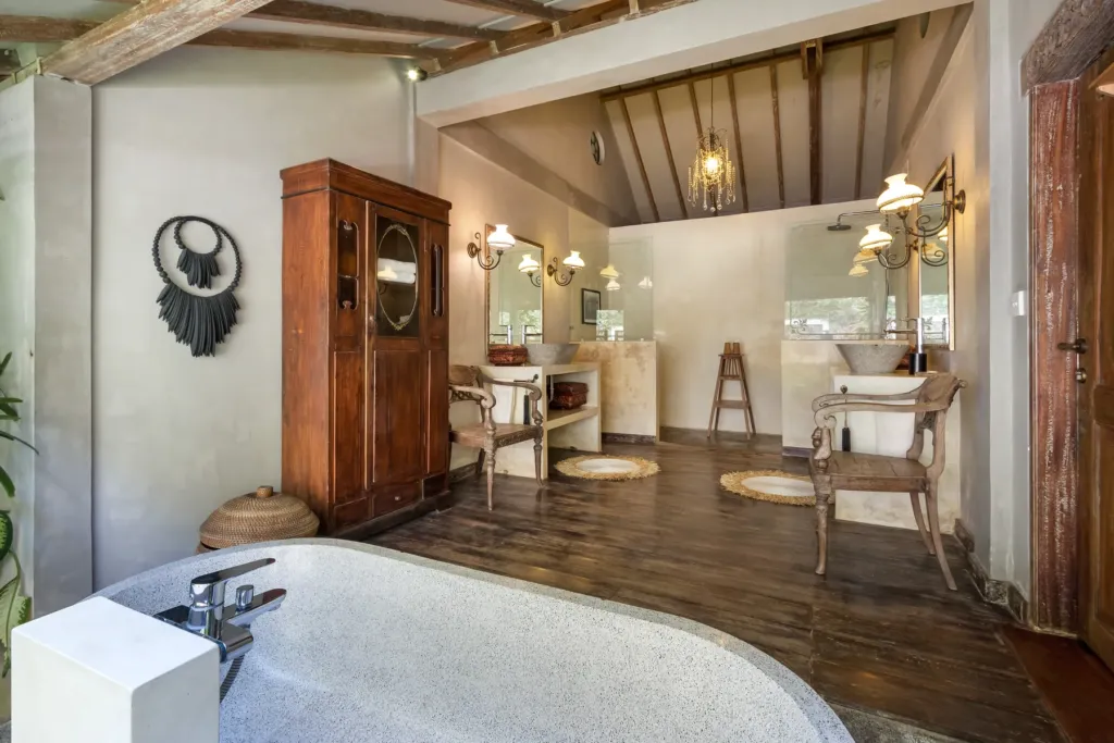 Twin stone basins and antique cabinet in the master en-suite at Villa Koyama