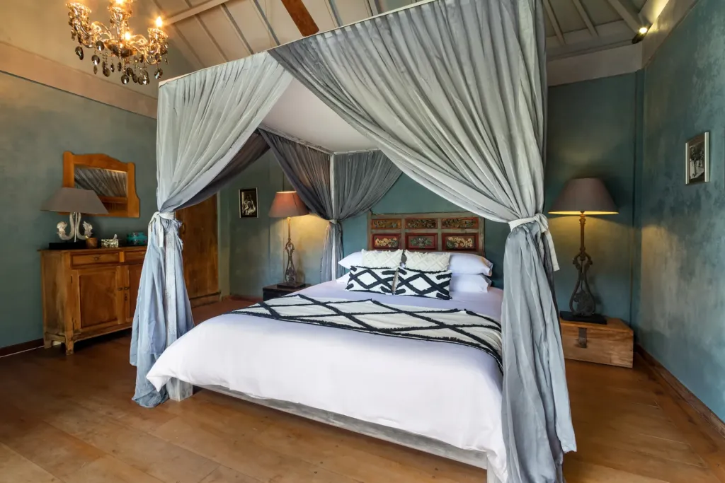 King bedroom at Villa Koyama with a draped four-poster bed