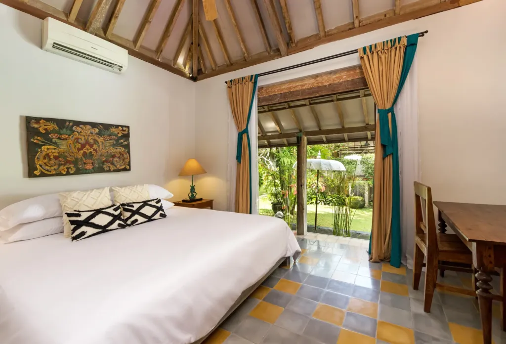 King bedroom at Villa Koyama opening onto the garden through glass doors