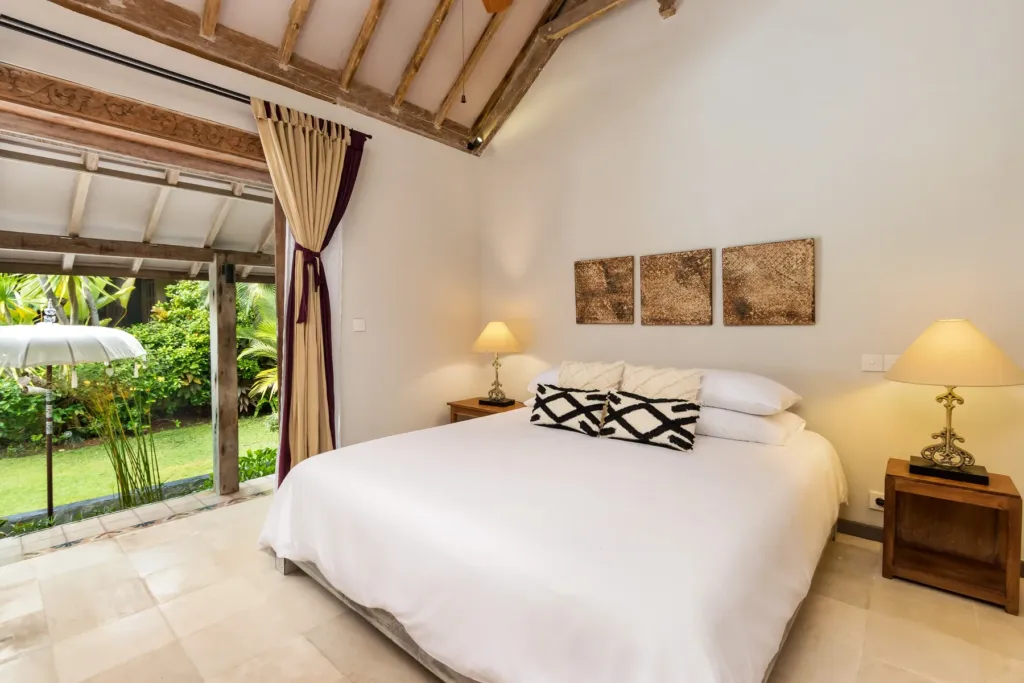 King bedroom in a garden pavilion at Villa Koyama, doors open to the lawn