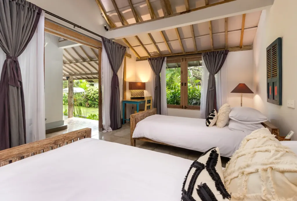 Twin room at Villa Koyama with garden doors and timber shutters