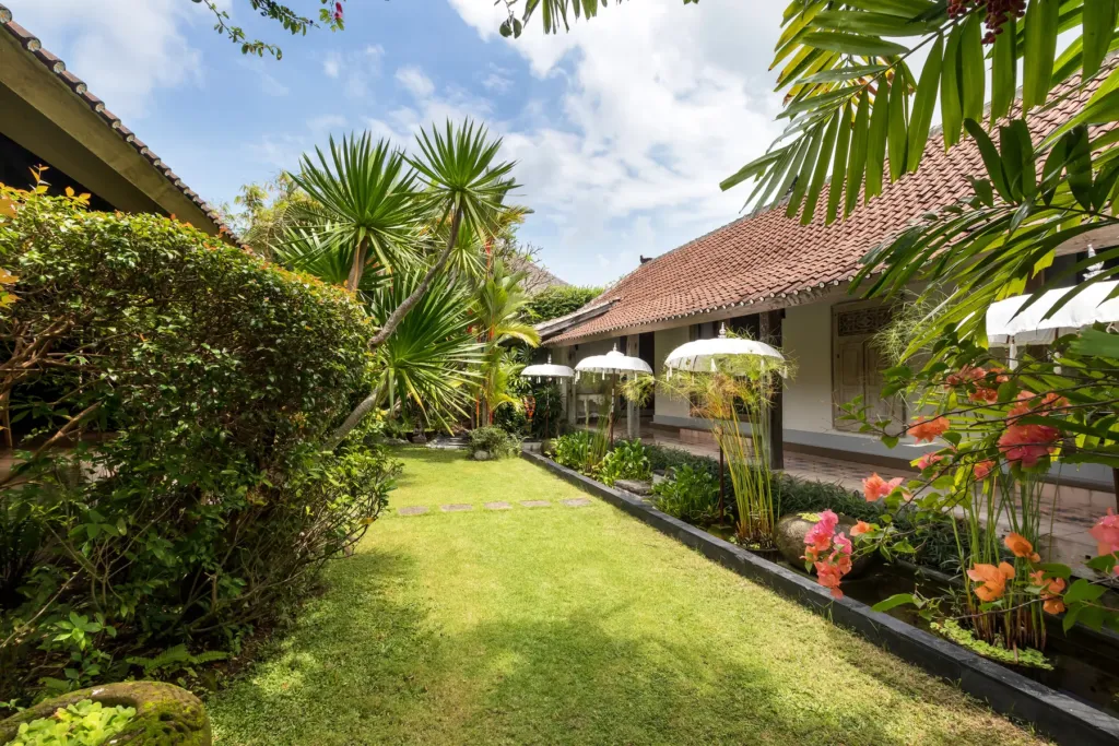 Lawn and flowering planting in Villa Koyama's walled garden