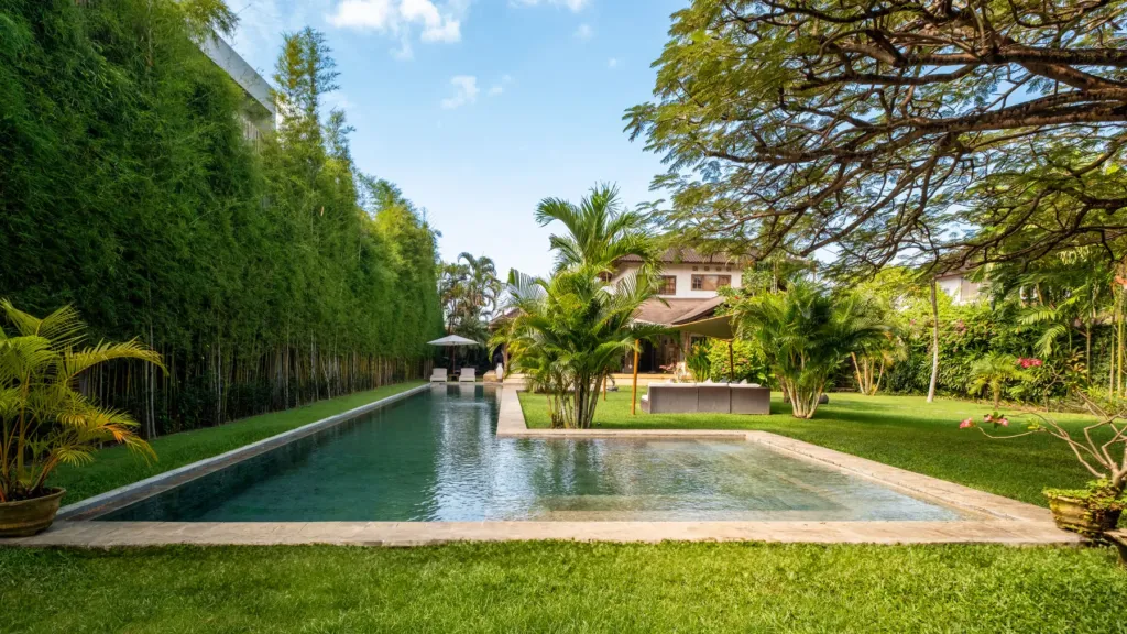 Villa Mogi, Seminyak — pool, view across the lawn to the pool and bamboo hedge at Villa Mogi