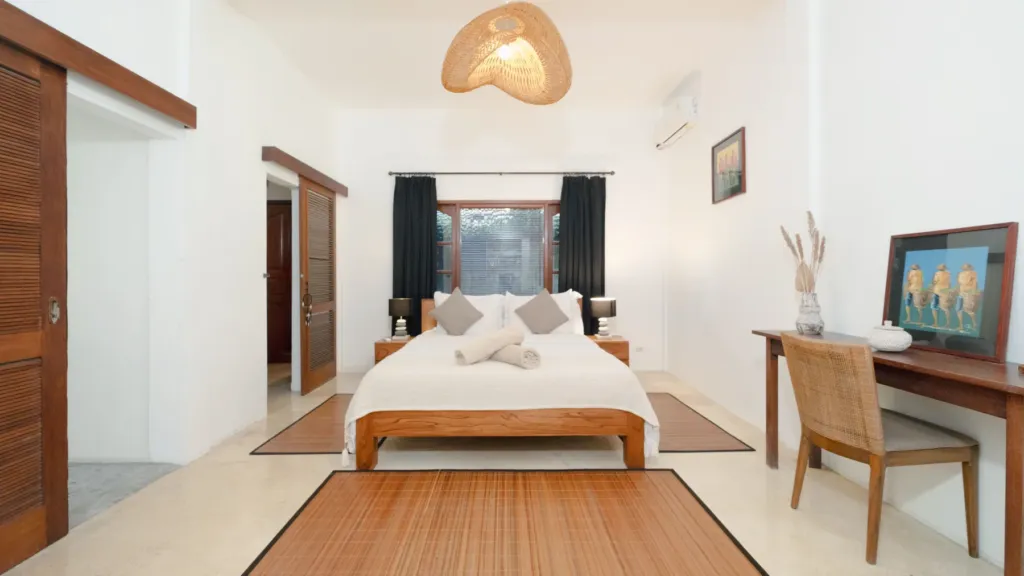 Villa Mogi, Seminyak — bedroom, king bedroom at Villa Mogi with rattan pendant light and timber bed