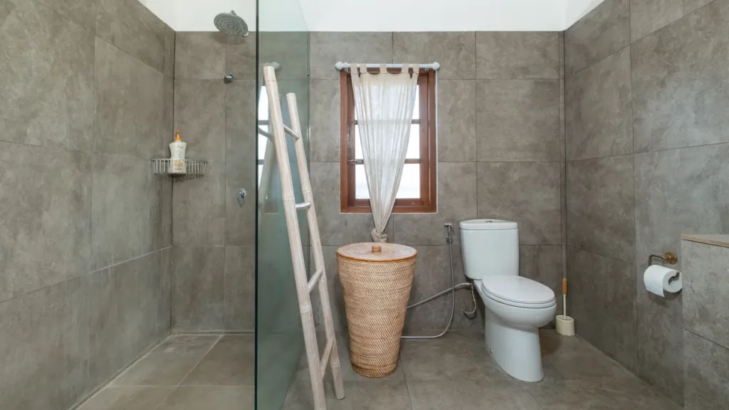 Villa Mogi, Seminyak — bathroom, concrete-finished bathroom at Villa Mogi with a walk-in shower