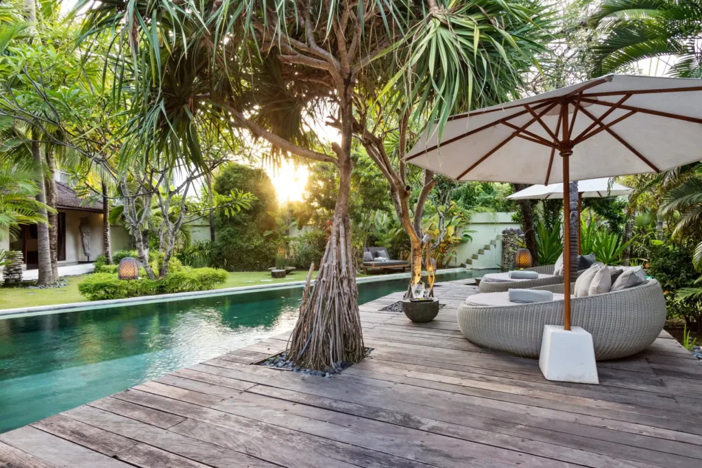 Late afternoon sun over the pool and garden at Villa Shantika
