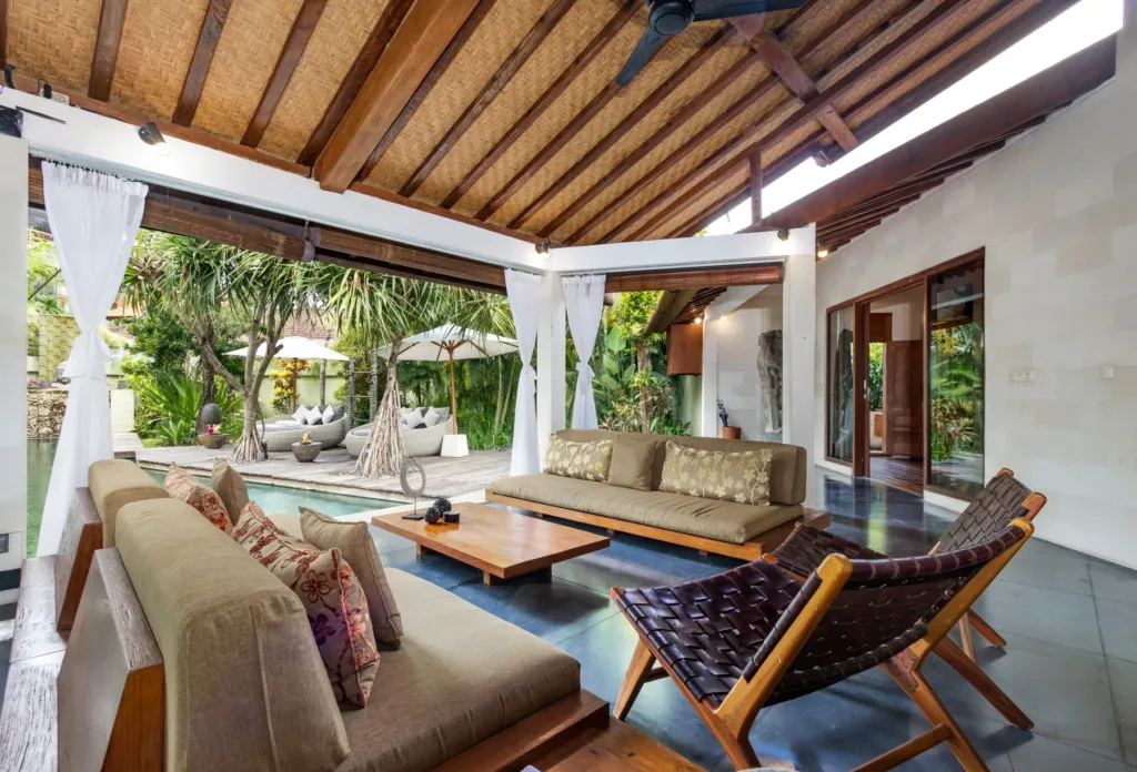 Deep sofas and white drapes in the living pavilion at Villa Shantika