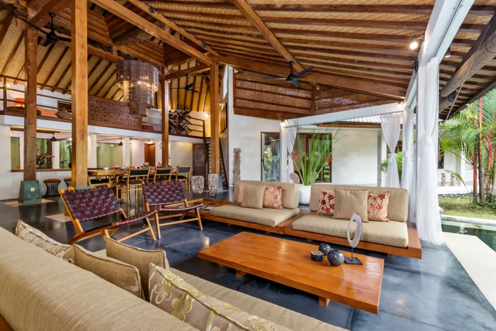 Living pavilion at Villa Shantika under a high timber roof, with the mezzanine above