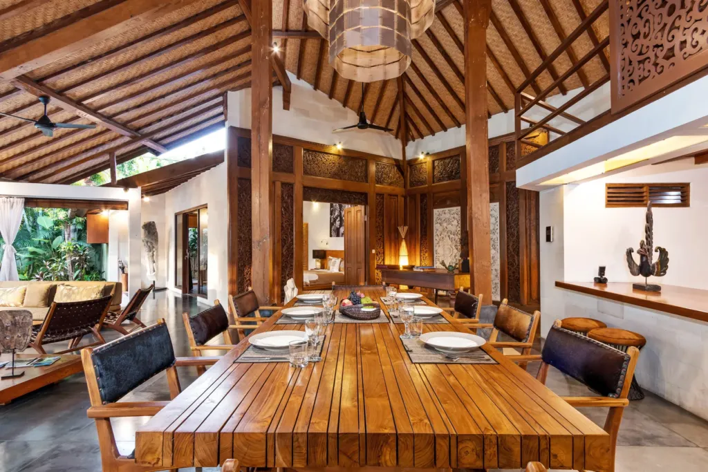 Dining table beneath the soaring timber ceiling at Villa Shantika