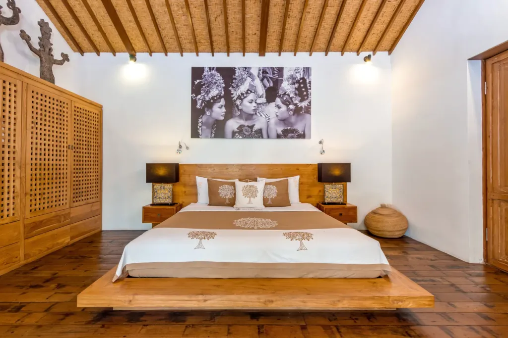 Master bedroom at Villa Shantika with a king bed on a timber platform