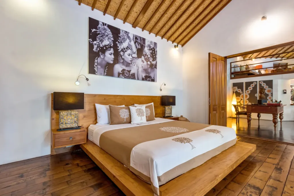 King master bedroom at Villa Shantika with timber floors and a pitched ceiling