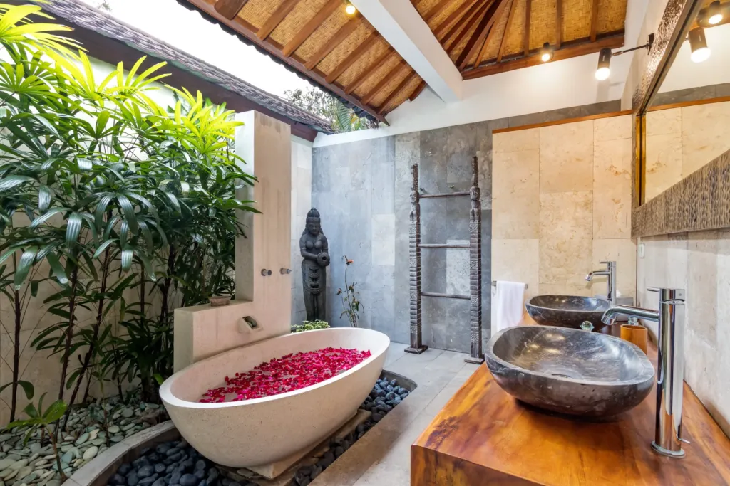 Freestanding terrazzo bathtub open to the sky in the master en-suite at Villa Shantika