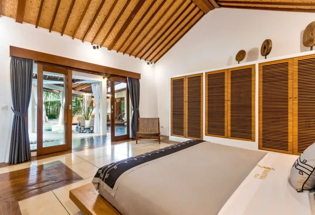Bedroom at Villa Shantika with doors opening straight onto the pool deck