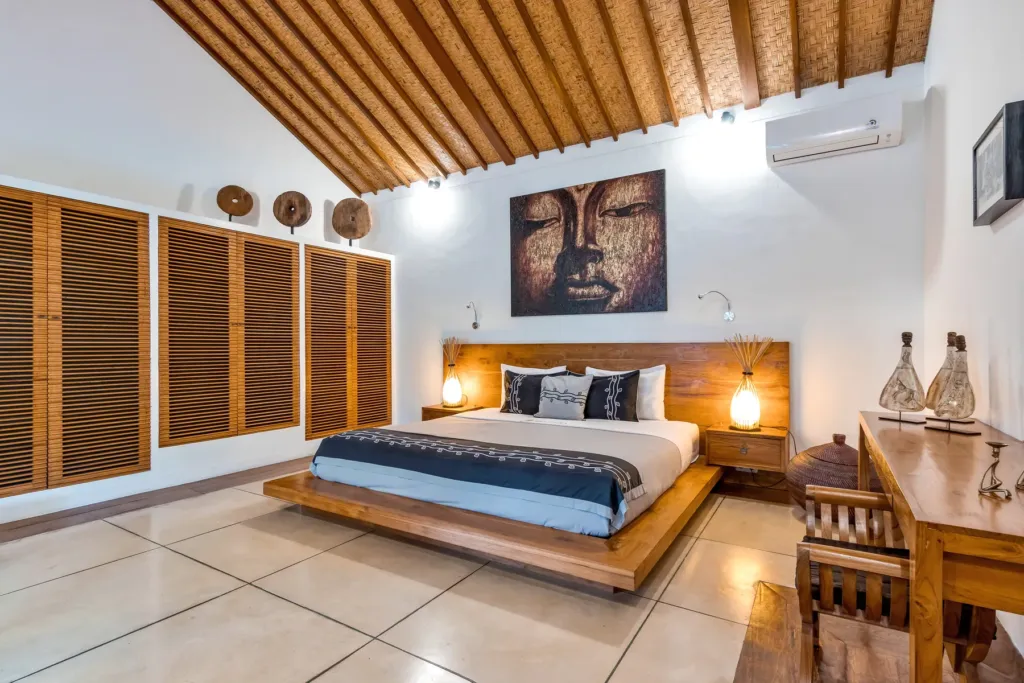 King bed and artwork in a bedroom at Villa Shantika