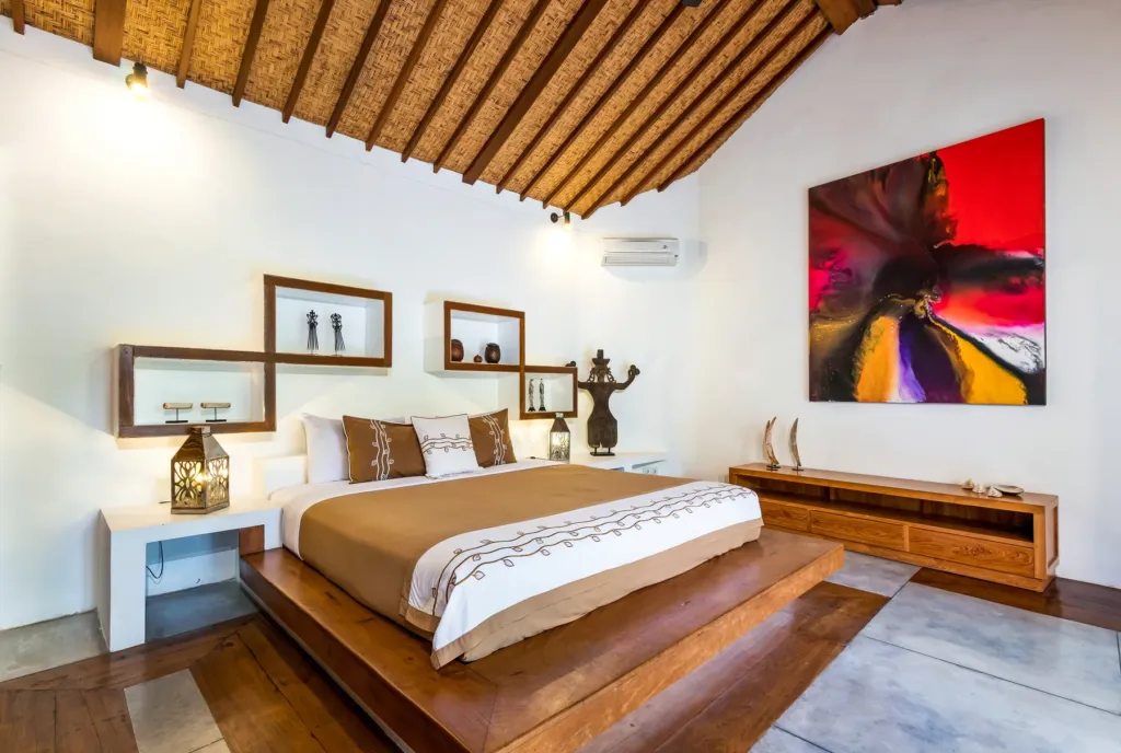King bed and contemporary artwork in a bedroom at Villa Shantika