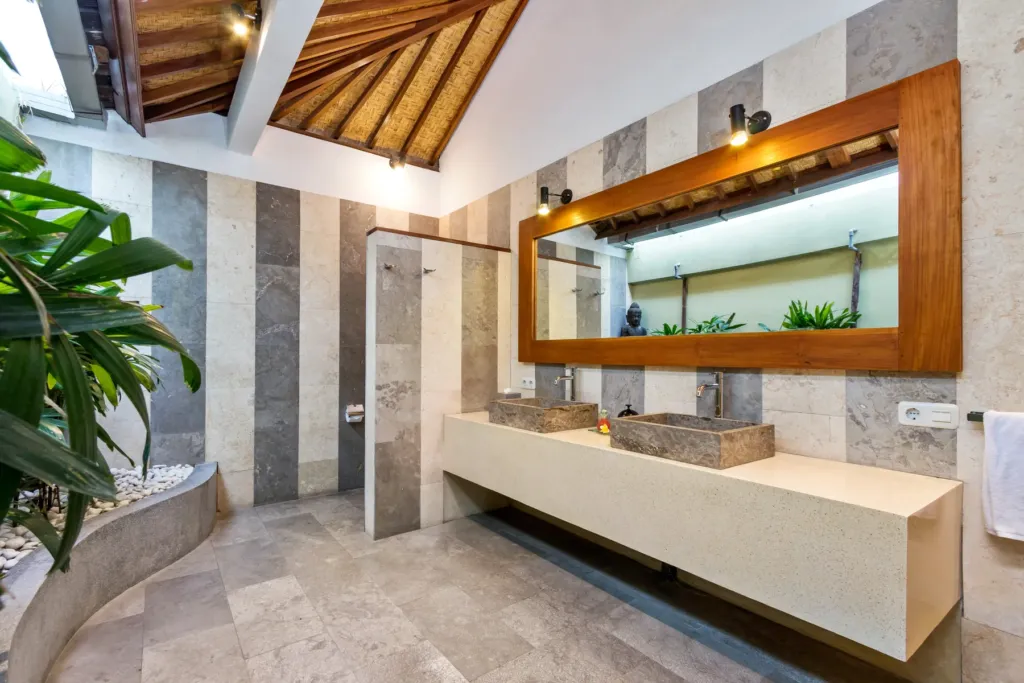 Open-air en-suite at Villa Shantika with a long stone counter and twin basins