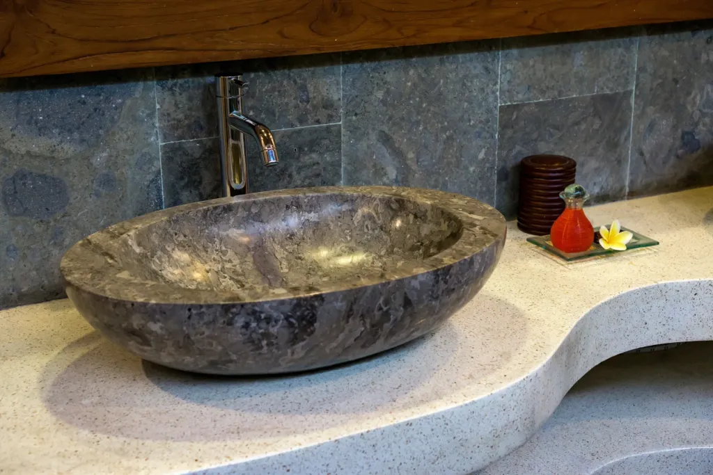 Carved stone basin detail in a bathroom at Villa Shantika