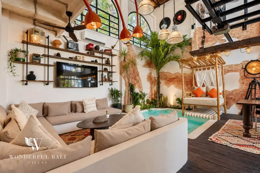3BR villa for sale in Berawa — double-height industrial living room with an indoor plunge pool and daybed