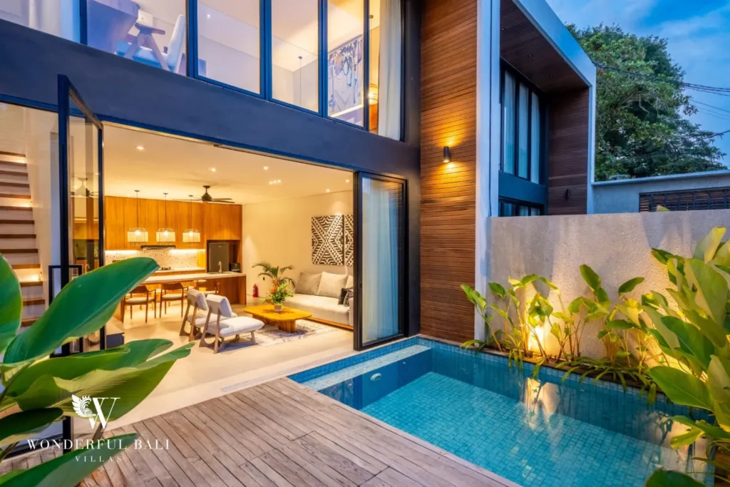 3BR villa for rent in Seminyak — pool, pool lit at dusk below the double-height living room