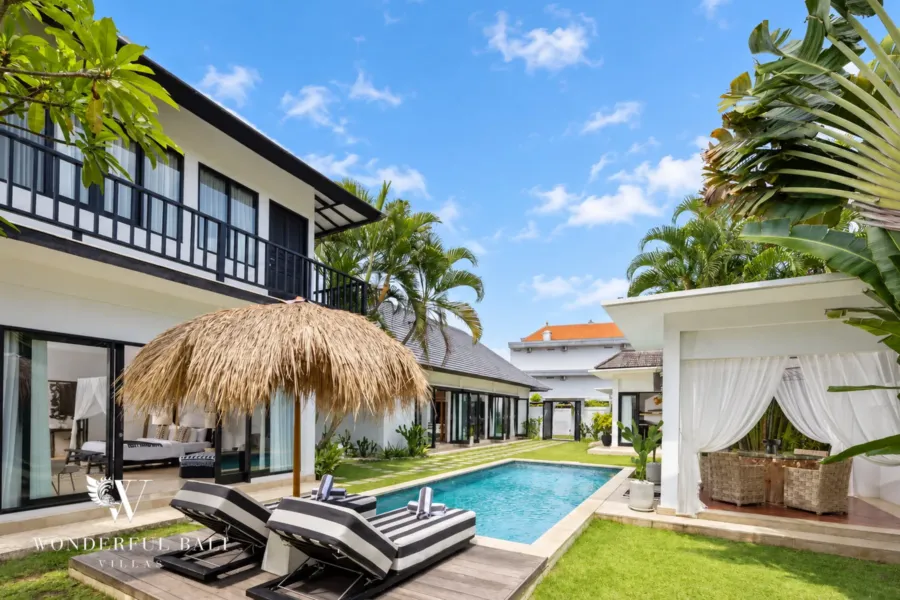 4BR villa for rent in Batu Bolong, Canggu — pool, lap pool and lawn with the thatched garden bale and villa behind