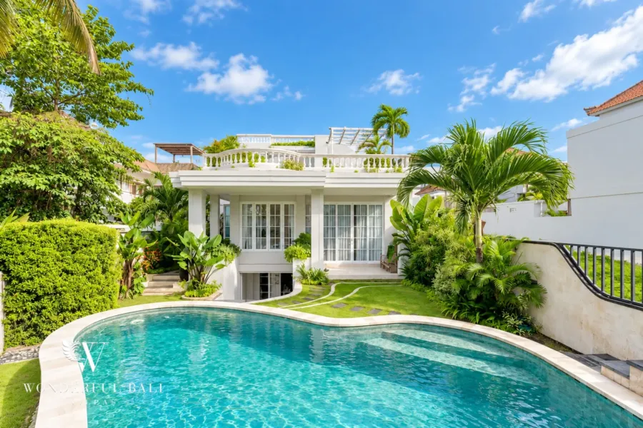 5BR villa for sale in Pererenan — colonial-style villa with curved pool, tropical garden and rooftop terrace