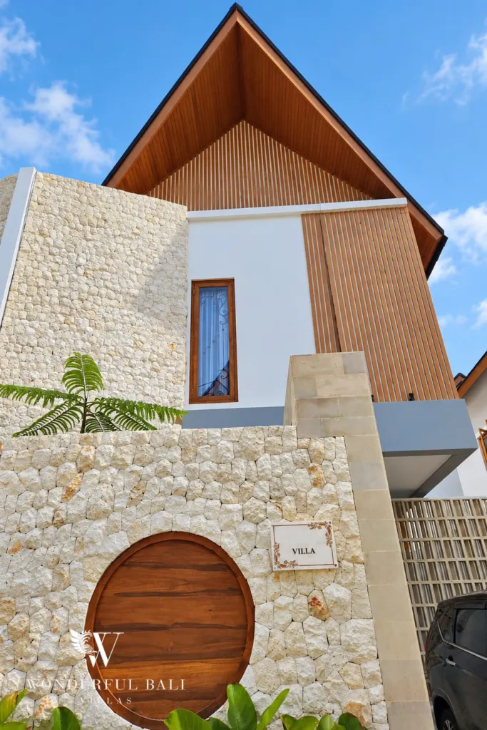 3BR villa for rent in Sanur — modern tropical villa with stone wall and timber gable in a gated Kesiman community