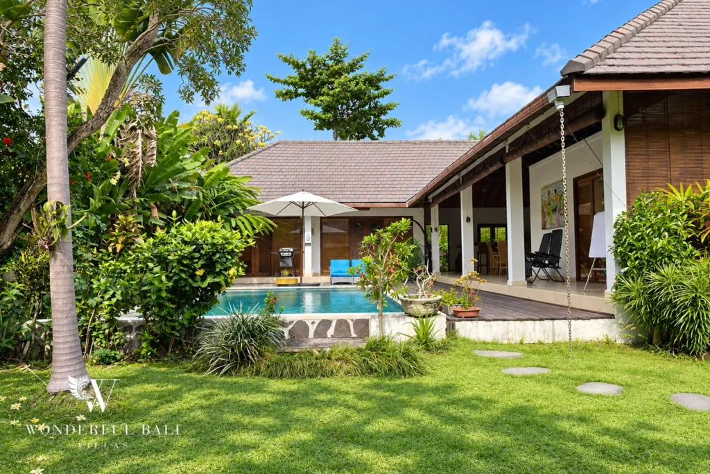 3BR villa for rent in Padonan, Canggu — pool, lawn and overflow pool in front of the tiled-roof living pavilion