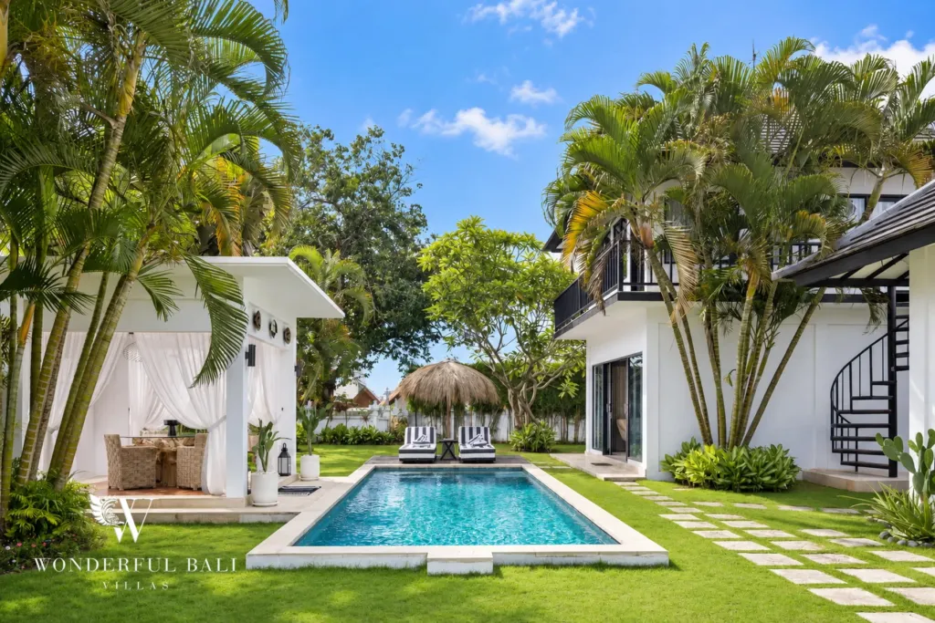 4BR villa for rent in Batu Bolong, Canggu — pool, long lap pool set in lawn between the pavilions and palms