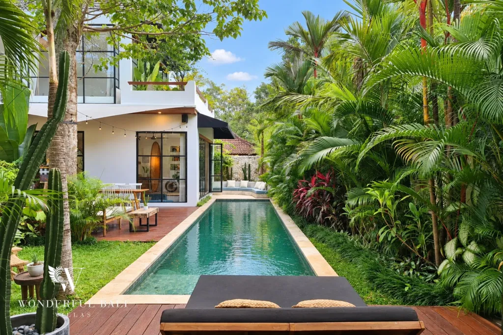 5BR villa for rent in Seseh, Bali — pool, lap pool running between the lawn and dense tropical planting
