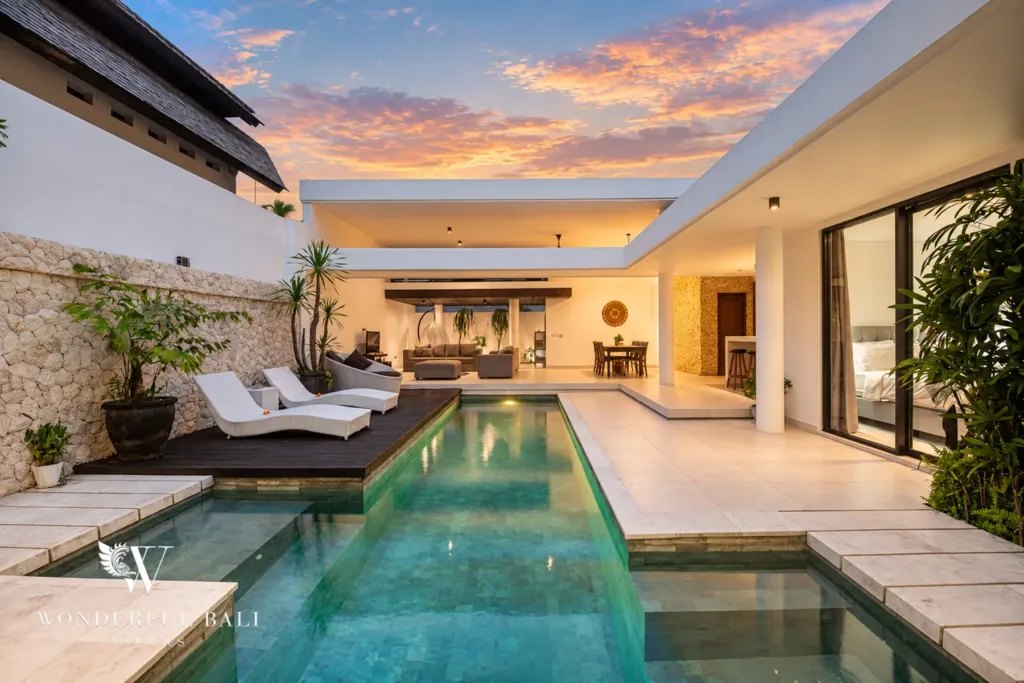 3BR villa in Berawa, Canggu, Bali — exterior, the pool courtyard lit at sunset