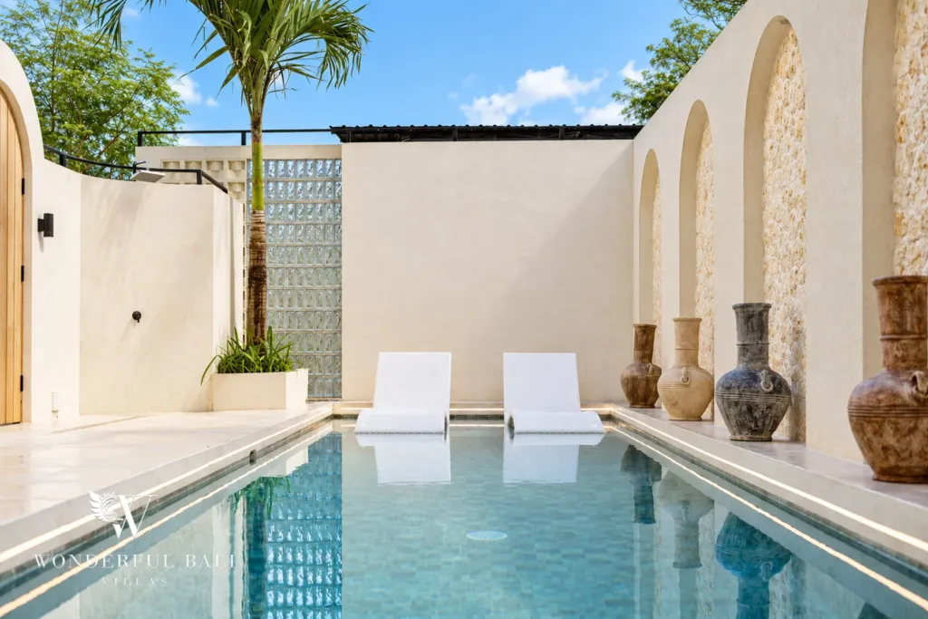 3BR villa for rent in Berawa, Canggu — pool, sun loungers beside the pool in the walled courtyard