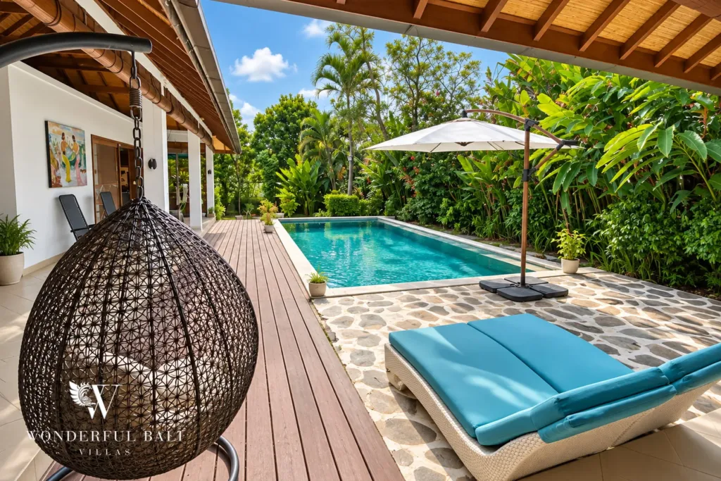 3BR villa for rent in Padonan, Canggu — pool, hanging rattan chair and daybed on the timber pool deck