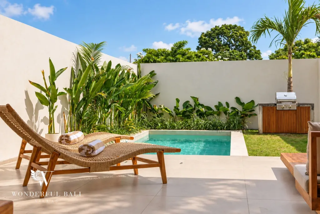 2BR villa for rent in Padonan, Canggu — pool, timber sun loungers on the pool deck beside the BBQ