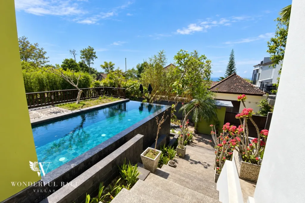 3BR villa for sale in Jimbaran — pool, 3.5 x 7 m pool with dark stone edging beside a lawn