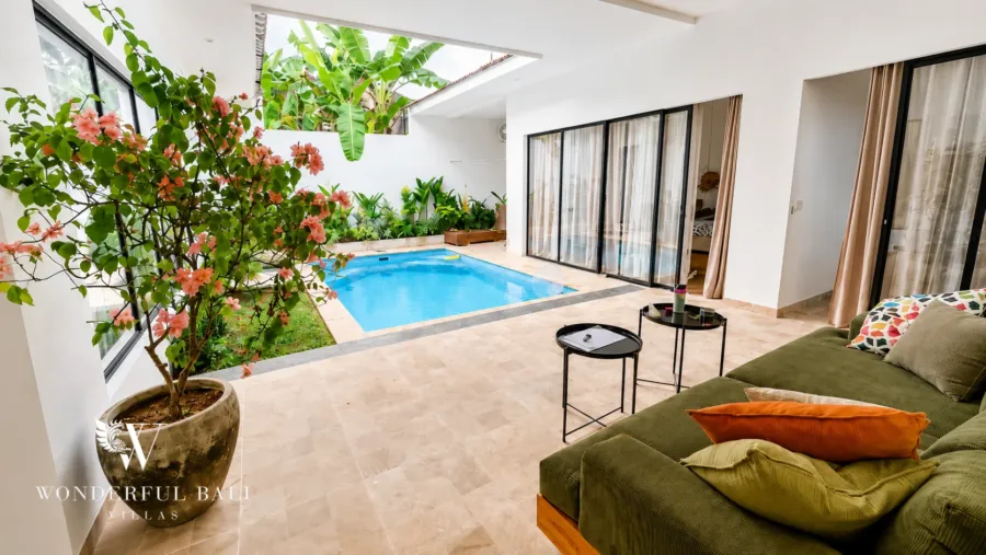 3BR villa for rent in Umalas — living room, enclosed lounge opening through sliders onto the pool