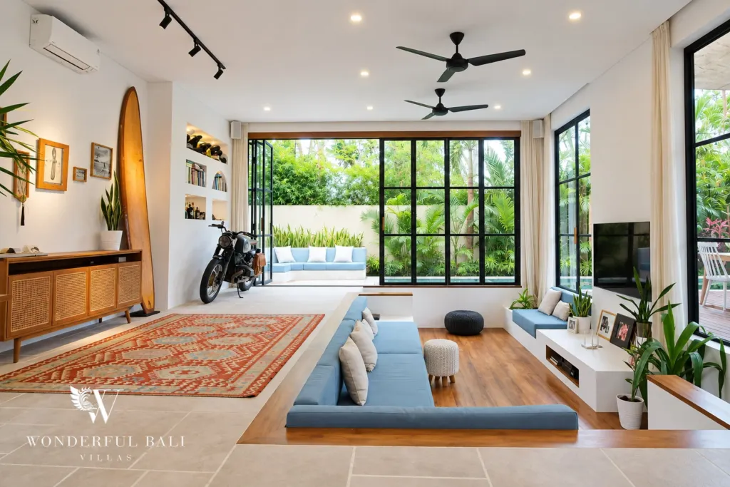 5BR villa for rent in Seseh, Bali — living room, sunken lounge with a kilim rug and glass doors onto the garden
