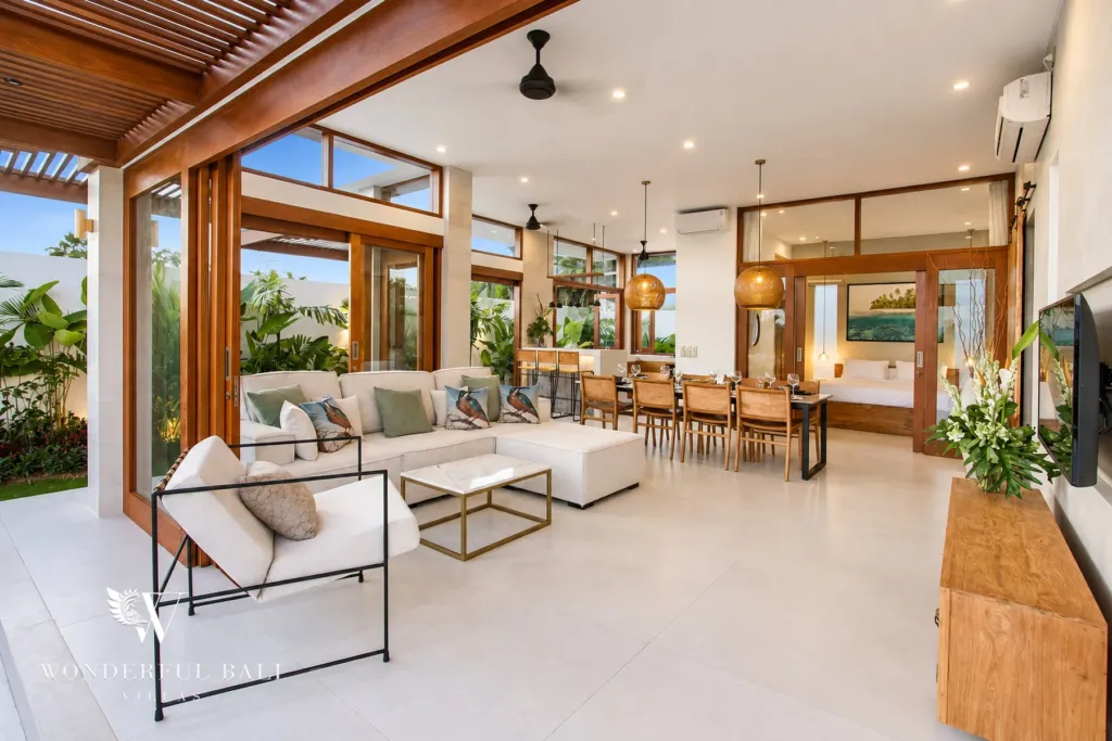 4BR villa for rent in Cemagi — living room, sofas, dining table and timber sliding doors to the garden