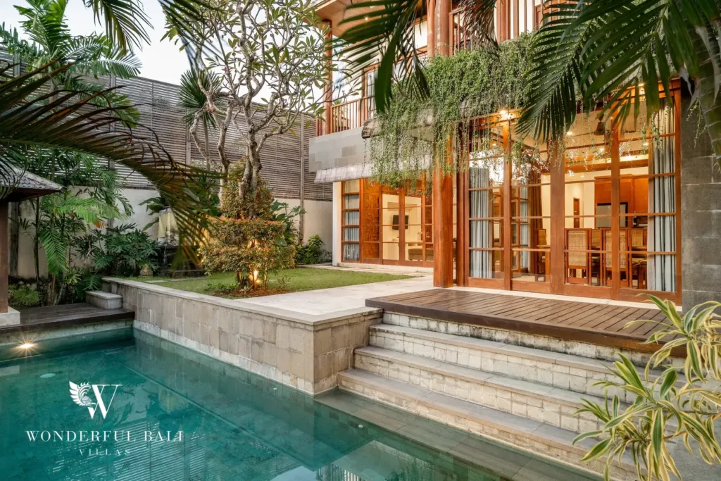 3BR villa for rent in Batu Belig, Seminyak — pool, pool and planted terrace steps up to the timber-framed garden doors