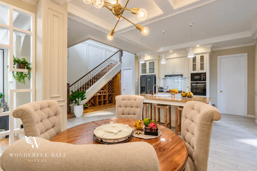 5BR villa for sale in Pererenan — round dining table beside the island kitchen and staircase