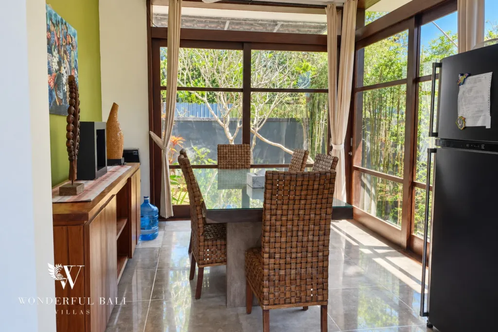 3BR villa for sale in Jimbaran — dining area, dining table for six framed by floor-to-ceiling windows
