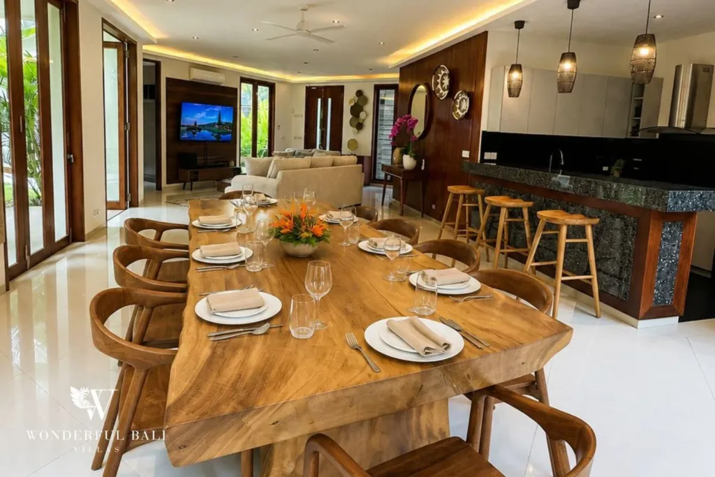 4BR villa for rent in Padonan, Canggu — dining, live-edge dining table with the kitchen bar beyond