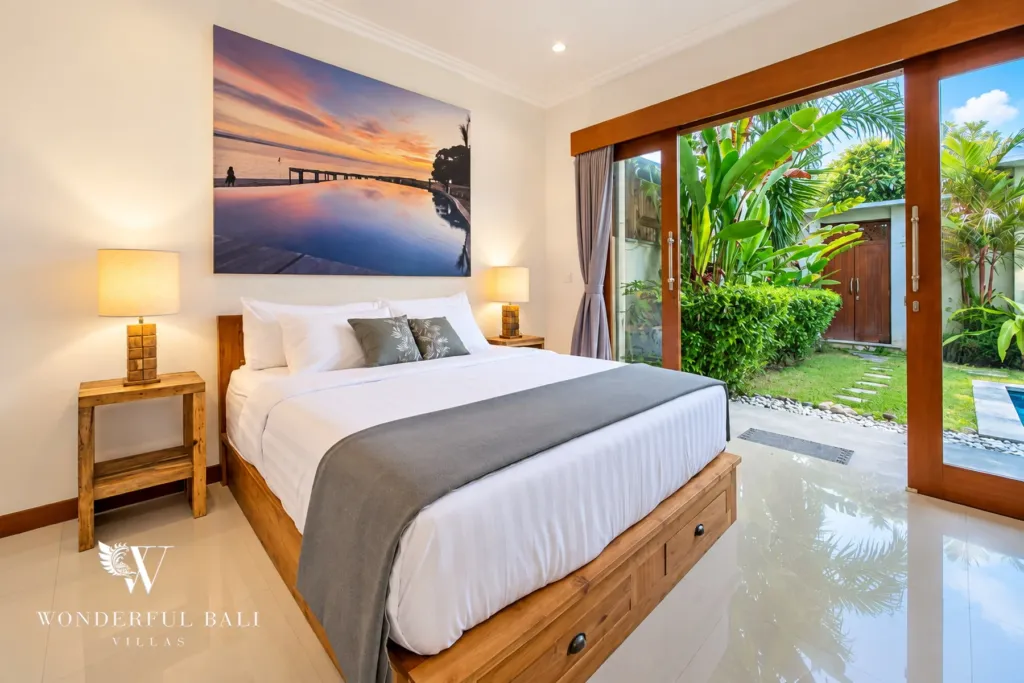 4BR villa for rent in Umalas, Bali — bedroom, sliding doors onto the garden and a stepping-stone path