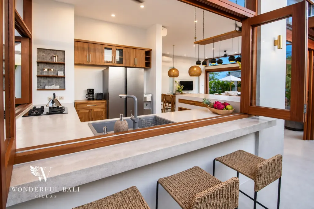 4BR villa for rent in Cemagi — kitchen, stone breakfast bar, gas hob and double-door fridge