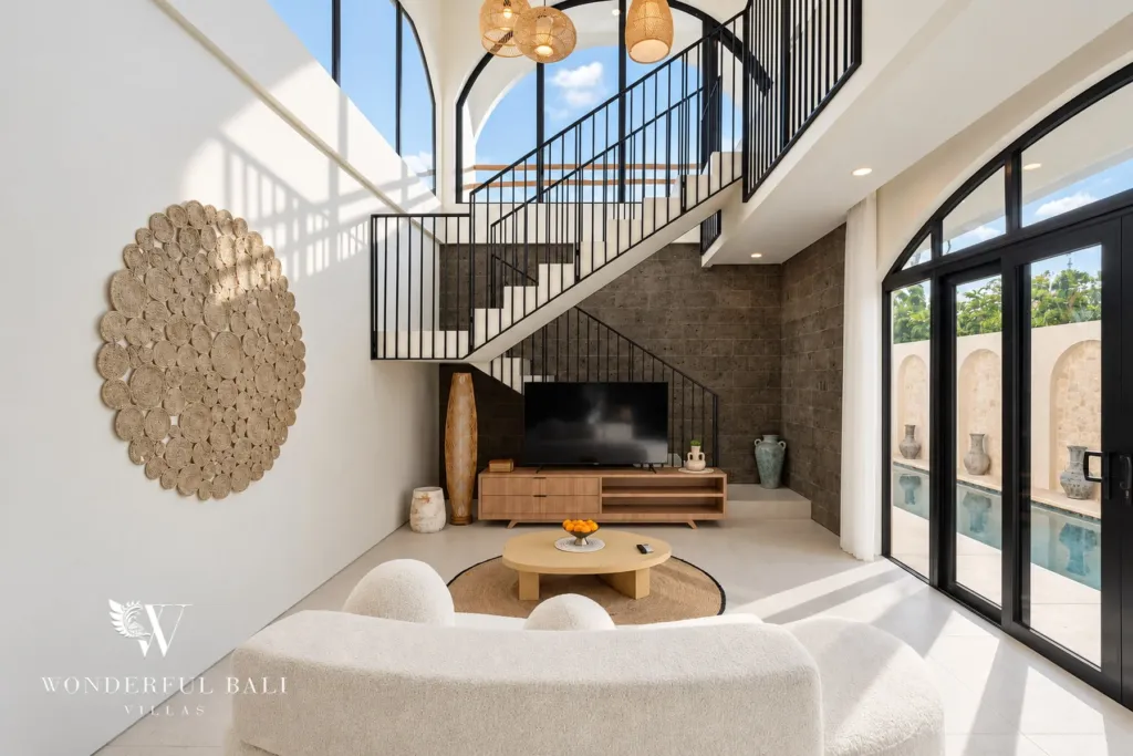 3BR villa for rent in Berawa, Canggu — living room, double-height living room with a staircase and doors to the pool