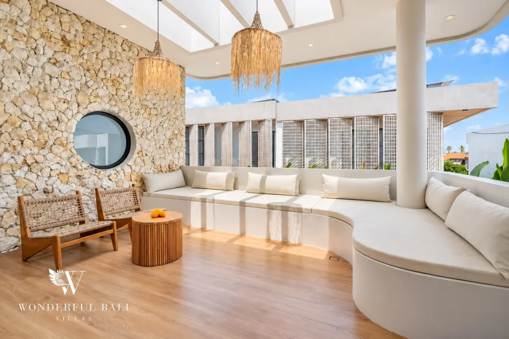 3BR villa for rent in Umalas, Bali — living room, built-in sunken seating around a low table under rattan pendants