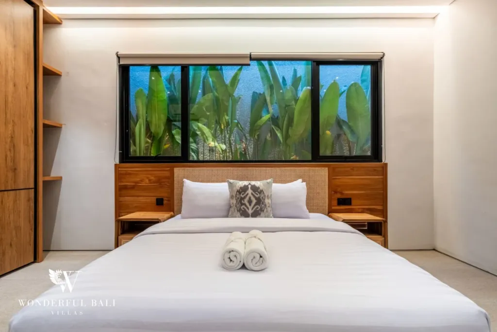 3BR villa for rent in Seminyak — bedroom 3, bed below a window onto the planted courtyard
