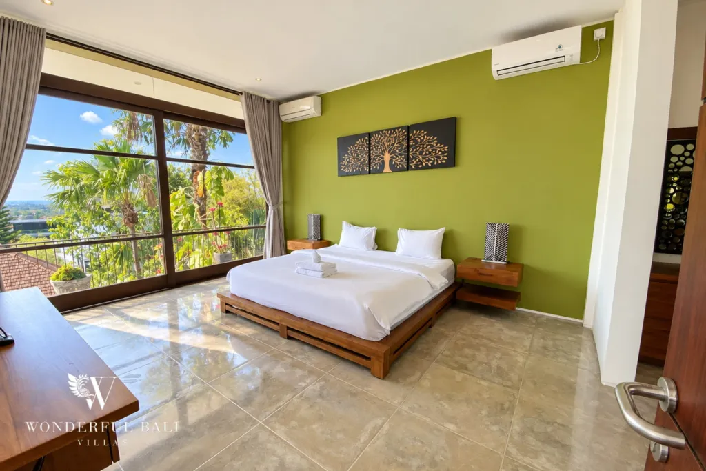 3BR villa for sale in Jimbaran — bedroom, bedroom with a green feature wall, desk and garden views
