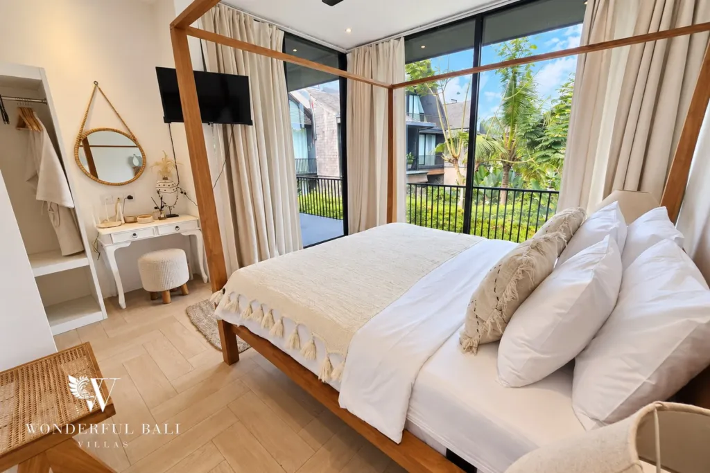 4BR villa for rent in Berawa, Canggu — bedroom, bedroom with a timber canopy frame, dressing table and full-height glass