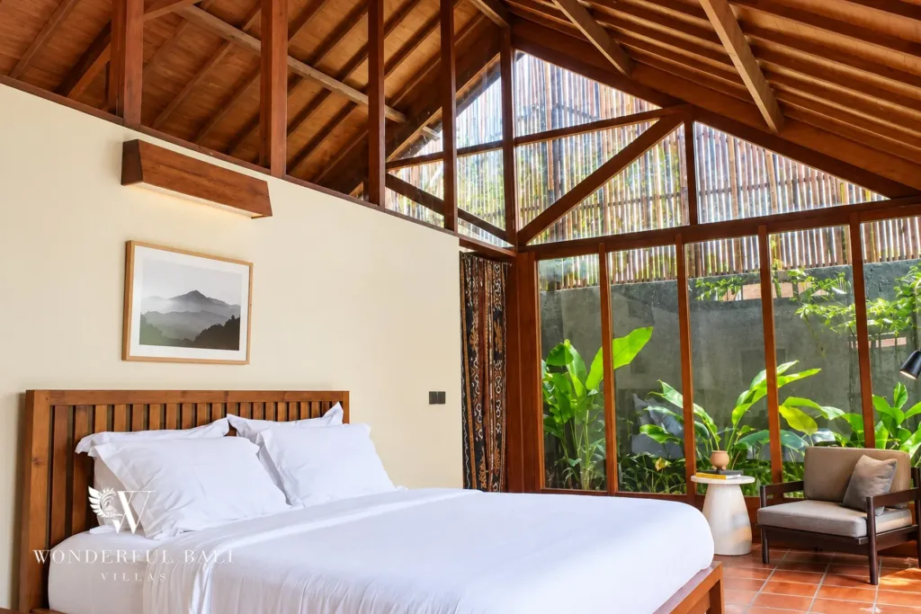 2BR villa for rent in Seseh — main bedroom with timber roof and garden glass wall