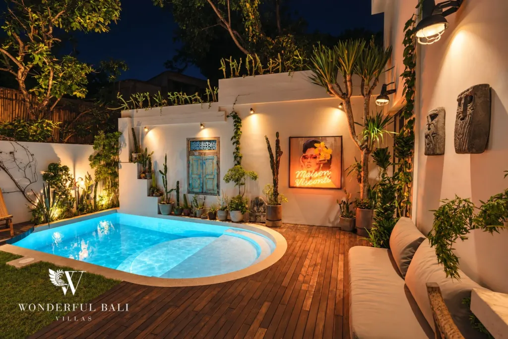 2BR villa for rent in Berawa, Canggu — pool, the courtyard pool lit at night with warm wall lighting and planting